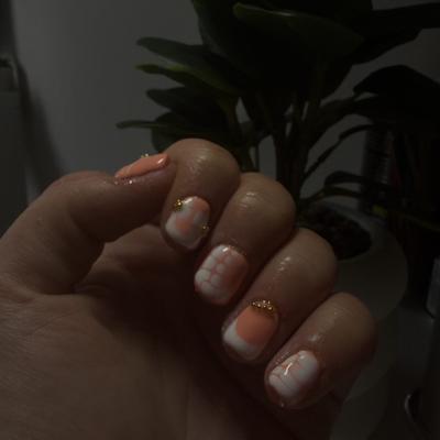 Soft peach french tips finished with fine gold glitter accents